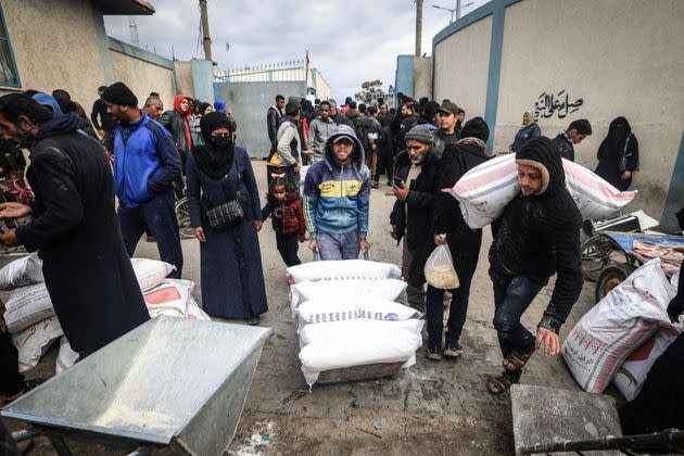 Displaced Palestinians receive food aid at the United Nations Relief and Works Agency for Palestine Refugees (UNRWA) center in Rafah in the southern Gaza Strip on Jan. 28, 2024, amid ongoing battles between Israel and the Palestinian militant group Hamas.
