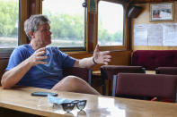 Danny Collier gestures as he sits in his boat, the Princess Freda on the river Thames in London, Friday, May 8, 2020. Danny and his brother John Collier are the proud owners of the boats the Princess Freda, the Queen Elizabeth, the Connaught and the Clifton Castle. All four boats have had their moment in the sun. And all four were meant to have another on Friday as Britain celebrates the 75-year anniversary of Victory in Europe Day. Instead, they're lying idle on the banks of the River Thames, not far from Kew Gardens in southwest London, as the festivities surrounding VE Day have been all but cancelled as a result of the coronavirus pandemic. For the brothers it’s nothing less than a disaster, one that could spell the demise of the company their late father created in 1975. (AP Photo/ Vudi Xhymshiti)