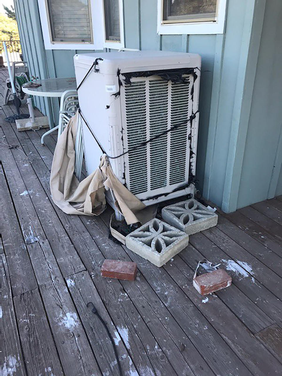 California condor droppings are left scattered over a porch after a flock of the rare, endangered birds took over the deck over the weekend in Tehachapi, Calif. About 15 to 20 of the giant endangered birds have recently taken a liking to the house in Tehachapi and have made quite a mess.(Cinda Mickols via AP)