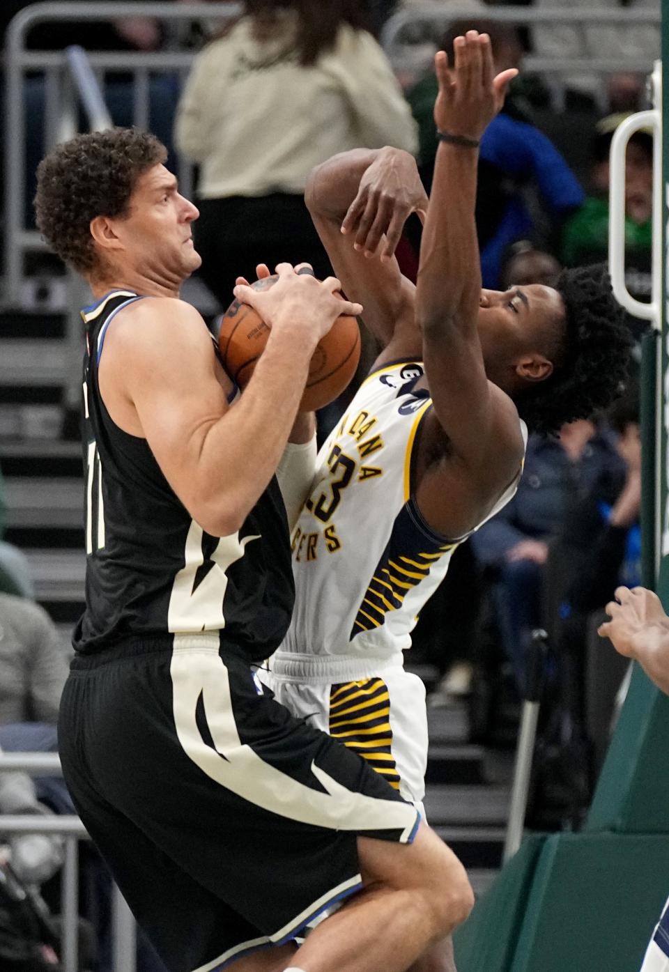 Bucks center Brook Lopez attempts to go up for a shot against Pacers forward Aaron Nesmith during the first half Monday at Fiserv Forum.