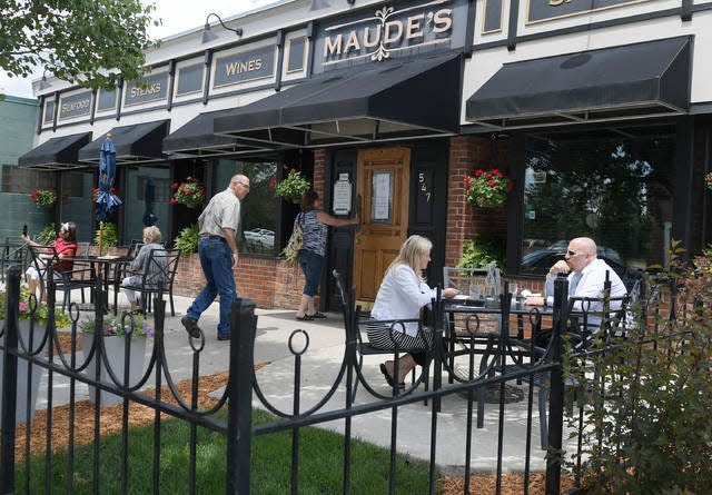 People enjoy meals in an outdoor dining area at Aunt Maude's restaurant in Ames' Main Street. Photo by Nirmalendu Majumdar/Ames Tribune