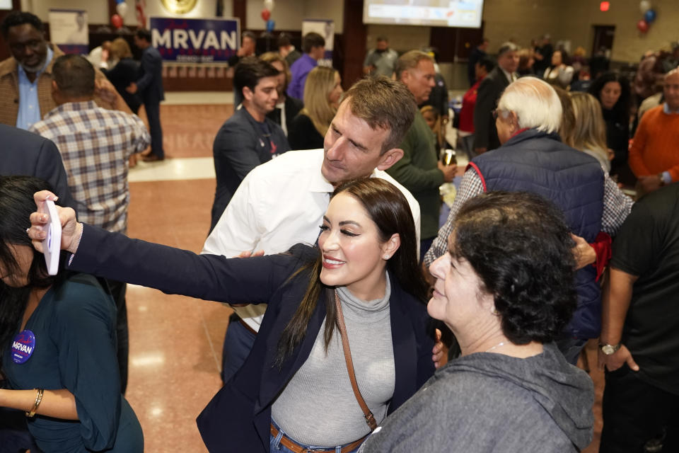 U.S. Rep. Frank Mrvan, D-Ind., poses for a selfie with supporters during an election night party Tuesday, Nov. 8, 2022, in Merrillville, Ind. (AP Photo/Charles Rex Arbogast)