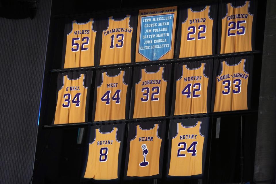 The retired jerseys of Los Angeles Lakers players Wilt Chamberlain (13), Shaquille O'Neal (34), Jerry West (44), Kareem Abdul-Jabbar (33) and Kobe Bryant (8 and 24) hang from the rafters at Crypto.com Arena.