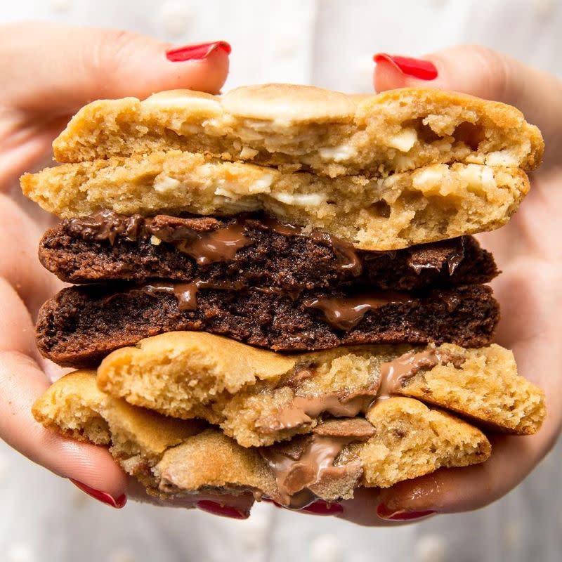 Person holding a stack of Ben's Cookies