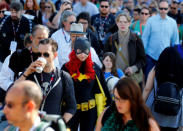 Gina Gianni of Chicago comes dressed as an animated Batgirl as she waits in a crowd to cross the street to attend Comic-Con. REUTERS/Mike Blake