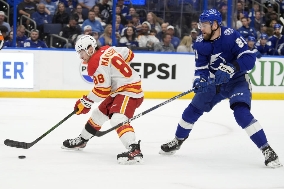 Calgary Flames left wing Andrew Mangiapane (88) works around Tampa Bay Lightning defenseman Erik Cernak (81) during the first period of an NHL hockey game Thursday, March 7, 2024, in Tampa, Fla. (AP Photo/Chris O'Meara)