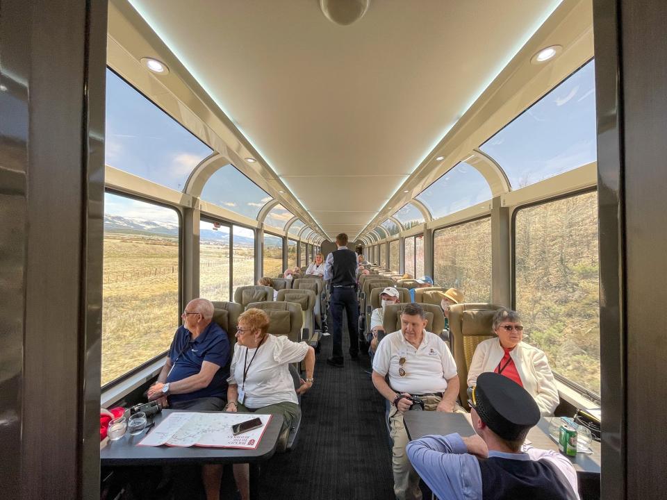 Zach Lucas speaks to passengers on the Rocky Mountaineer.