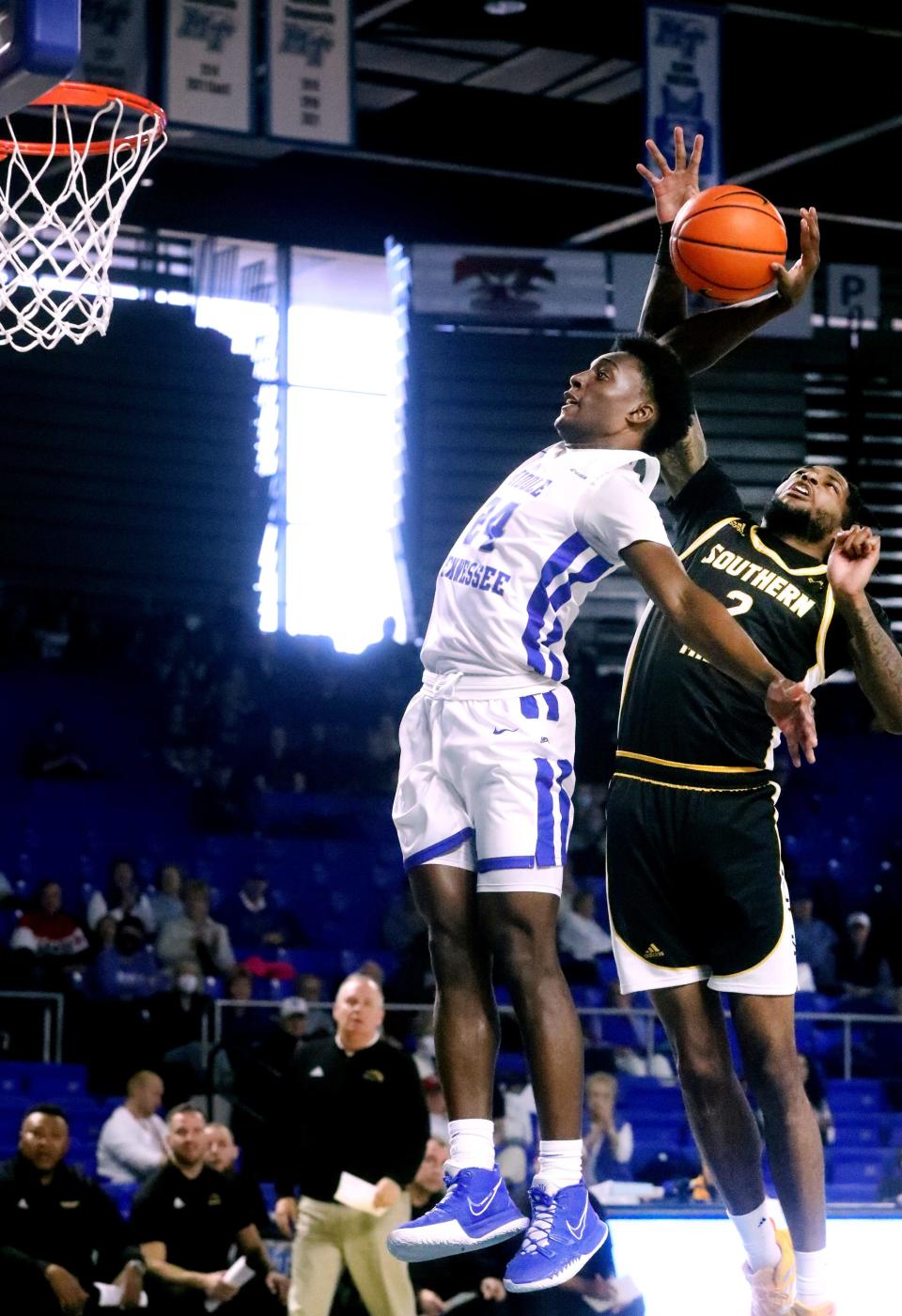 MTSU guard Camryn Weston (24) goes up for a dunk as Southern Miss forward Denijay Harris (2) knocks the ball away on Saturday, Jan. 22, 2022, at MTSU's Monte Hale Arena in Murphy Center in Murfreesboro, Tenn.