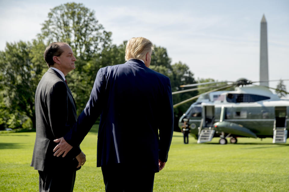 President Donald Trump speaks with Labor Secretary Alex Acosta, left, on the South Lawn of the White House in Washington, Friday, July 12, 2019, before Trump boards Marine One for a short trip to Andrews Air Force Base, Md. and then on to Wisconsin. Trump says Labor Secretary Alex Acosta to step down, move comes in wake of handling of Jeffrey Epstein case. (AP Photo/Andrew Harnik)