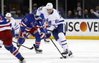 Toronto Maple Leafs' Ilya Mikheyev (65) skates up ice with New York Rangers' Filip Chytil (72) in pursuit during the first period of an NHL hockey game Wednesday, Jan. 19, 2022, in New York. (AP Photo/John Munson)