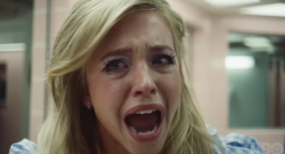 A distressed woman screams, close-up, from a TV show scene. She's expressing intense emotion