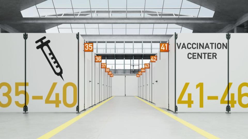 Temporary Corona vaccination center in warehouse with cabins.