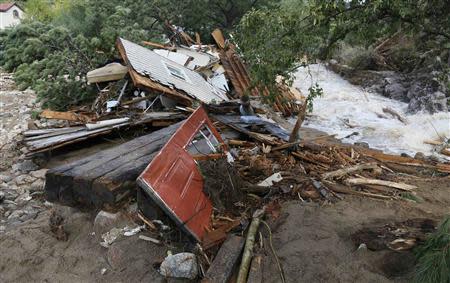 A destroyed house lies piled up against a tree in Jamestown, Colorado, after a flash flood destroyed much of the town, September 14, 2013. REUTERS/Rick Wilking