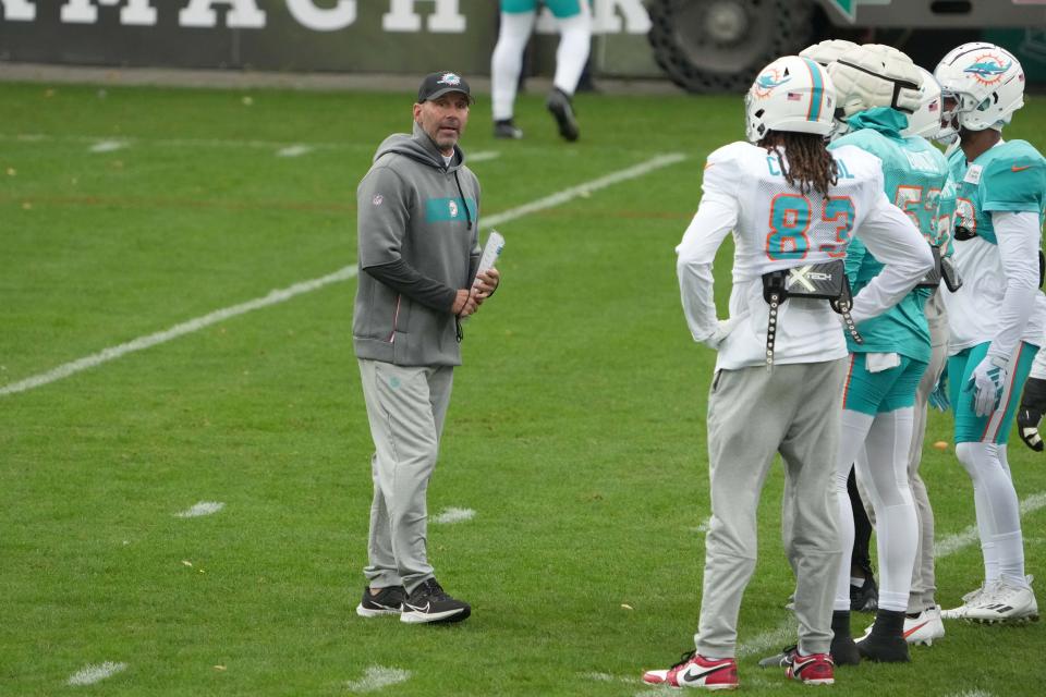 Nov 2, 2023; Frankfurt, Germany; Miami Dolphins special teams coordinator Danny Crossman (left) talks with wide receiver Raleigh Webb (83) and linebacker Cameron Goode (53) during practice at the PSD Bank Arena. Mandatory Credit: Kirby Lee-USA TODAY Sports