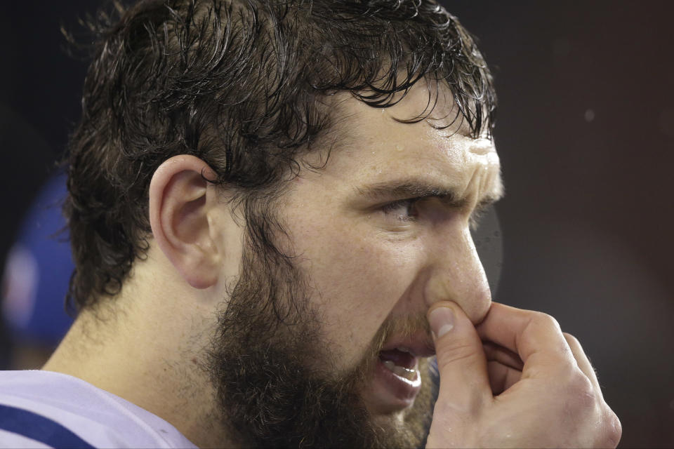 Indianapolis Colts quarterback Andrew Luck pinches his nose as he watches the action from the sidelines during the second half of an AFC divisional NFL playoff football game against the New England Patriots in Foxborough, Mass., Saturday, Jan. 11, 2014. (AP Photo/Stephan Savoia)