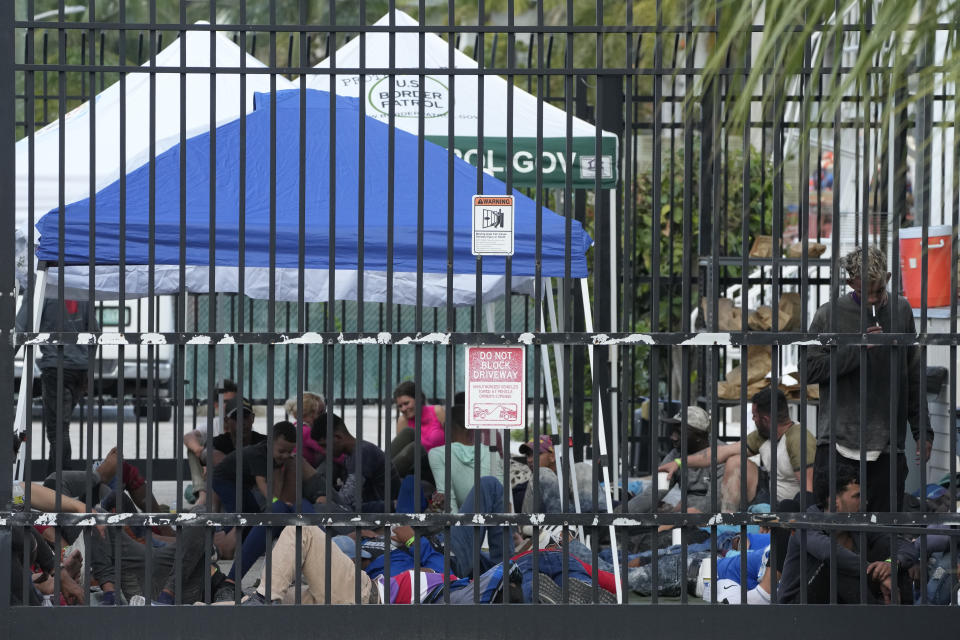 Recently arrived migrants wait in a garage area of the U.S. Customs and Border Protection - Marathon Border Patrol Station, Wednesday, Jan. 4, 2023, in Marathon, Fla. More than 500 Cuban immigrants have come ashore in the Florida Keys since the weekend, the latest in a large and increasing number who are fleeing the communist island. (AP Photo/Wilfredo Lee)