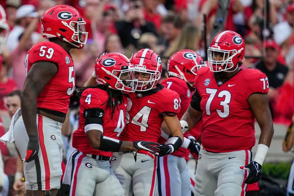 James Cook (4) celebrates with teammates after scoring a touchdown against South Carolina.