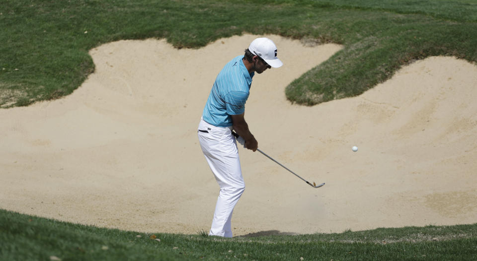 Will MacKenzie chips over a sand trap to the 18th green during the second round of the Texas Open golf tournament, Friday, March 28, 2014, in San Antonio. (AP Photo/Eric Gay)