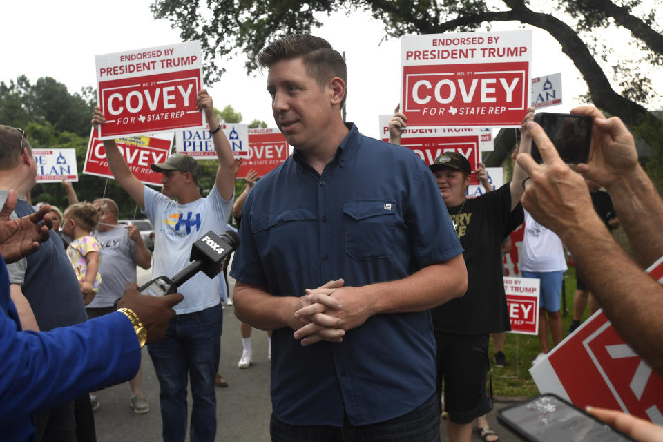 District 21 candidate David Covey talks with media as supporters gather behind him, attempting to block out the crowd for Texas House Speaker Dade Phelan at the Raymond Gould Community Center in Vidor, Texas, Tuesday, May 28, 2024. (Kim Brent/The Beaumont Enterprise via AP)