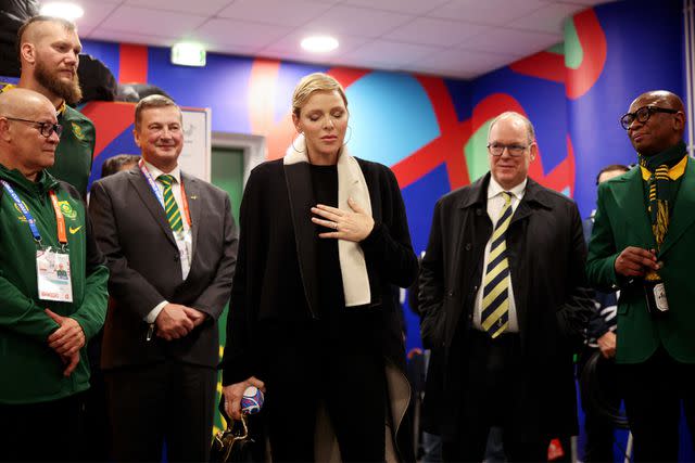 <p>Adam Pretty - World Rugby/World Rugby via Getty</p> Charlene, Princess of Monaco and Albert II, Prince of Monaco interact with the players of South Africa inside the South Africa dressing room following the Rugby World Cup France 2023 match between England and South Africa.