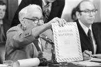 <p>Chairman Sam Ervin, D-N.C., holds up “sensitive material” envelope on June 5, 1973, in the Senate Caucus Room during the testimony of Sally J. Harmony before the Senate Watergate Committee. Ervin asked Harmony whether she could identify the envelope, she said she could not. (Photo: AP) </p>