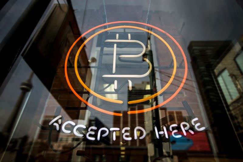 FILE PHOTO: A Bitcoin sign is seen in a window in Toronto