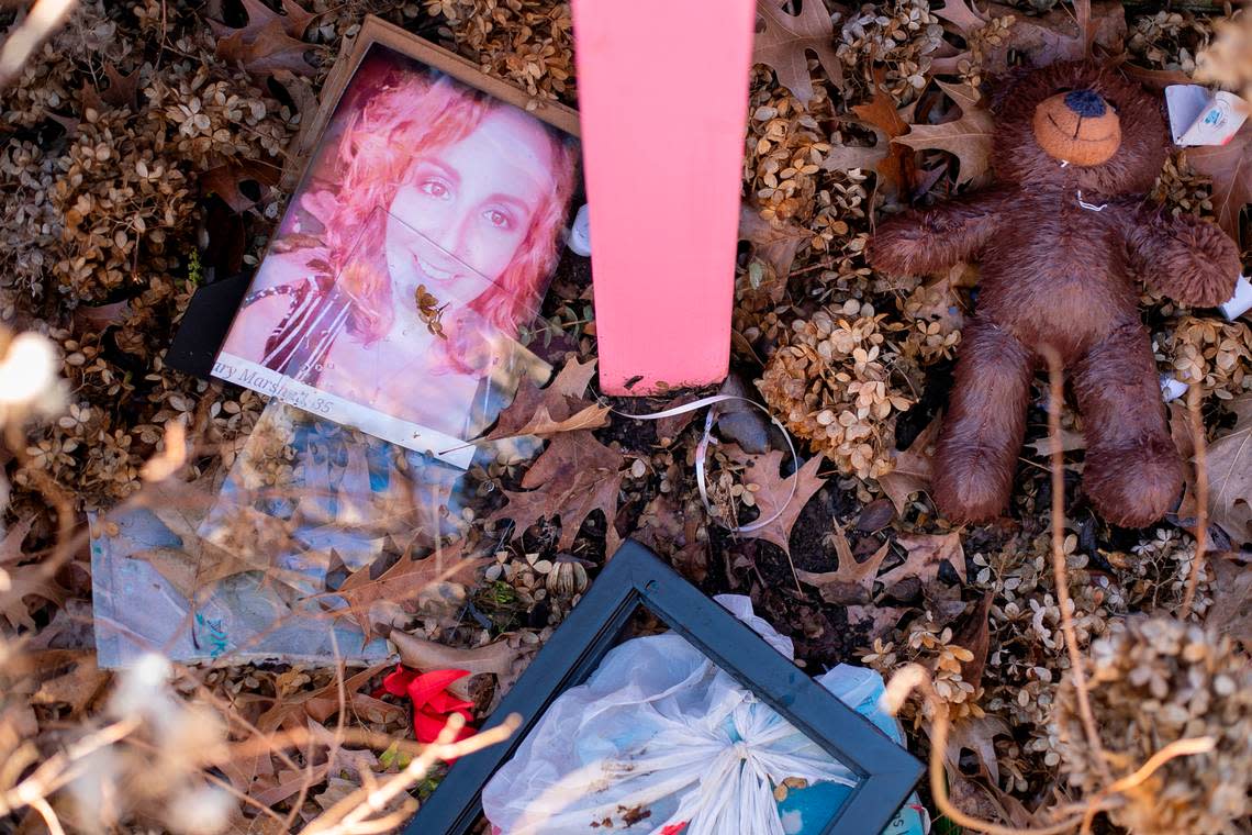 A photo of Mary Marshall, a teddy bear and various other items have fallen off the memorial for the victims of the mass shooting in the Hedingham neighborhood on Friday, January 13, 2023 in Raleigh, N.C.