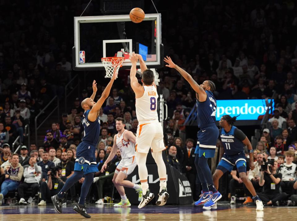 Phoenix Suns guard Grayson Allen (8) shoots over Minnesota Timberwolves center Rudy Gobert (27) during the first half at Footprint Center in Phoenix on April 5, 2024.