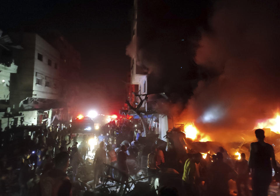 Palestinians gather around fire set on a destroyed house following an Israeli airstrike in Jabaliya refugee camp, on the outskirts of Gaza City, Saturday, Nov. 4, 2023. (AP Photo/Mohammed Alaswad)