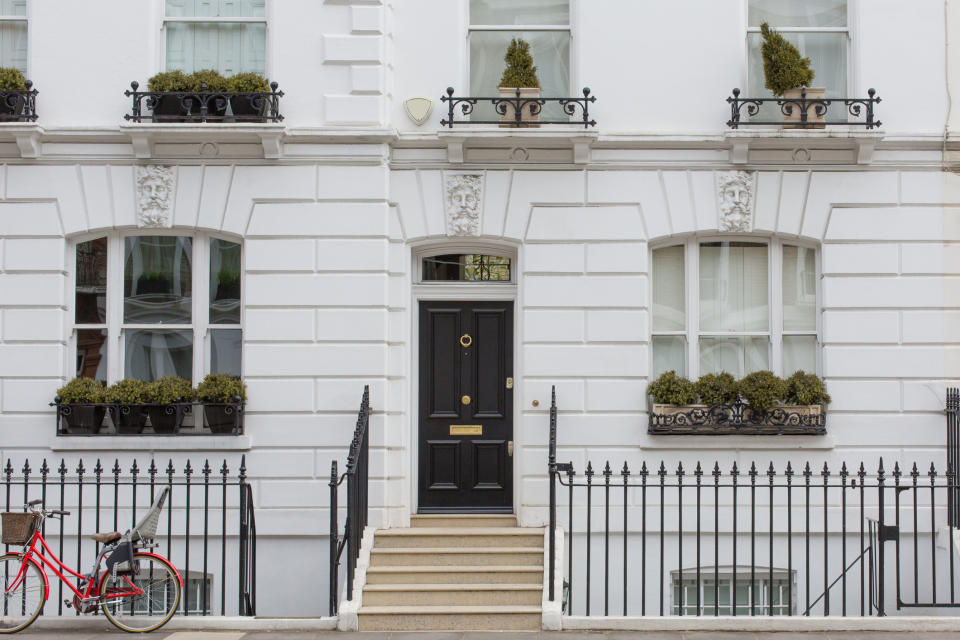 A black door on a white building in London.