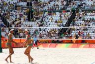 2016 Rio Olympics - Beach Volleyball - Women's Preliminary - Beach Volleyball Arena - Rio de Janeiro, Brazil - 06/08/2016. Empty seats are pictured behind Taliqua Clancy (AUS) of Australia and Louise Bawden (AUS) of Australia. REUTERS/Ruben Sprich