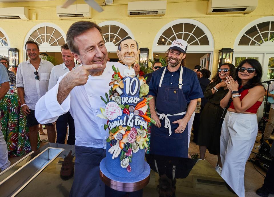 Chef Daniel Boulud is surprised with a special cake to celebrate his 10th year at the Palm Beach Food and Wine Festival. Boulud hosted a festival brunch at his Café Boulud Palm Beach Sunday.