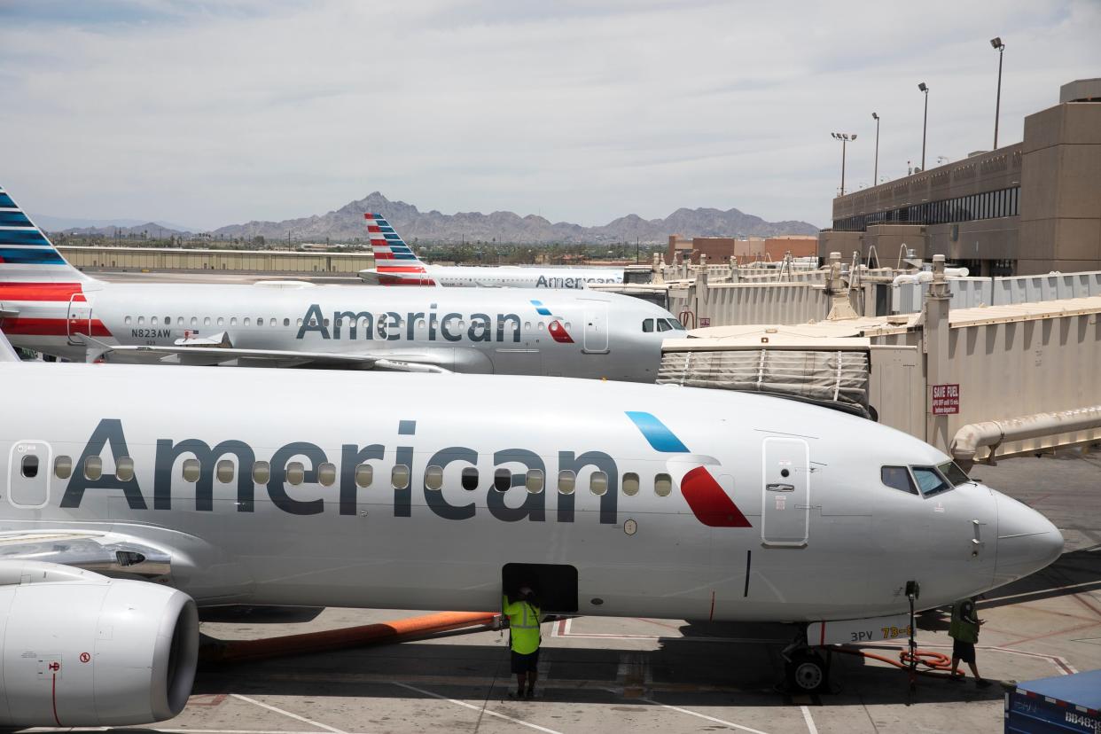 American Airlines aircraft wait at gates at Phoenix Sky Harbor International Airport in Phoenix, on June 7, 2021.