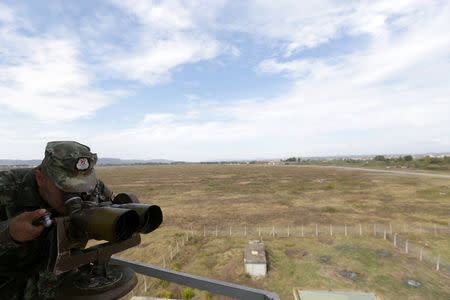 An Albanian Military Force member use uses binoculars in Kucova Air Base in Kucova, Albania, October 3, 2018. REUTERS/Florion Goga