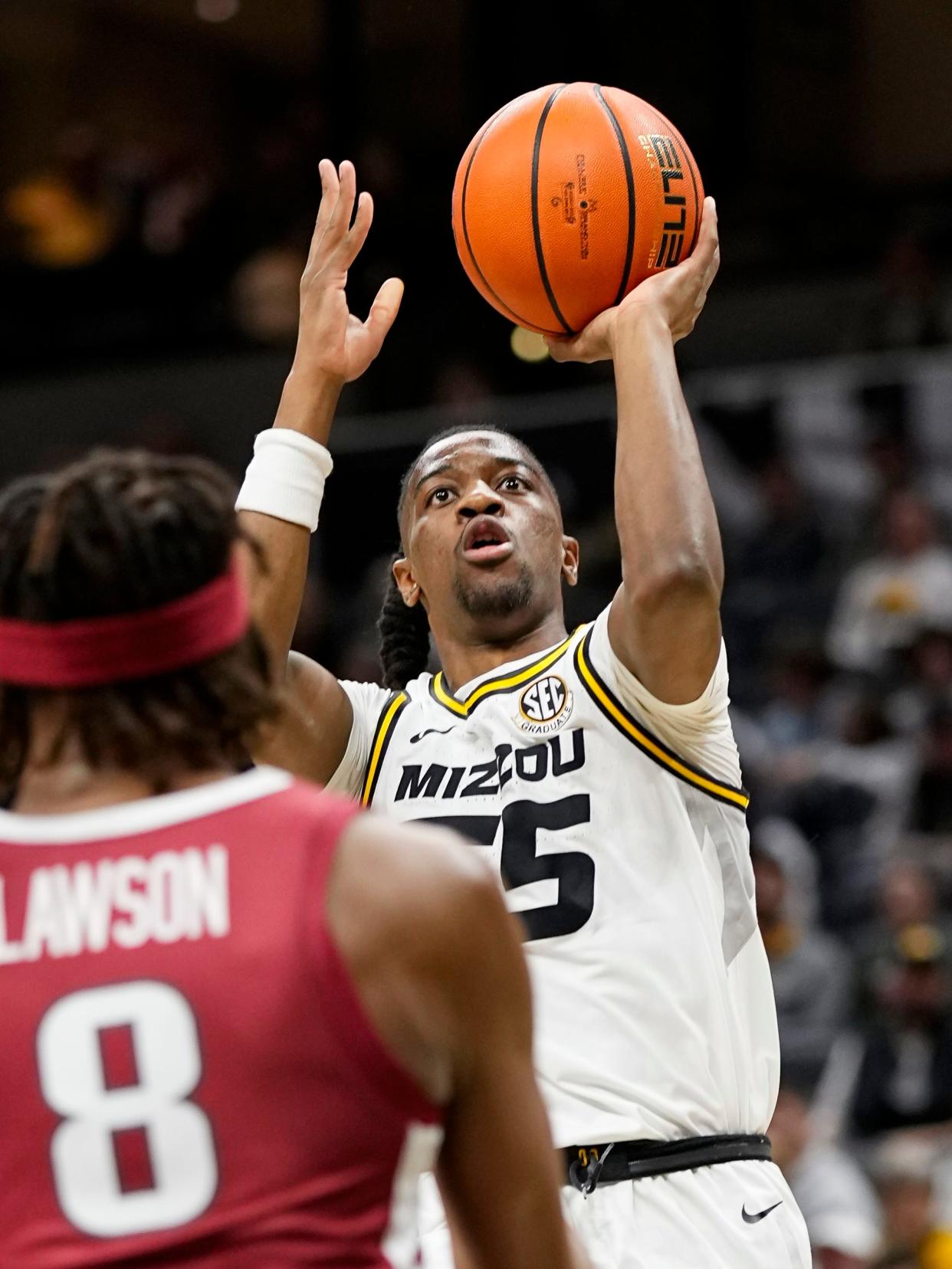 Jan 31, 2024; Columbia, Missouri, USA; Missouri Tigers guard Sean East II (55) shots against Arkansas Razorbacks forward Chandler Lawson (8) during the first half at Mizzou Arena. Mandatory Credit: Jay Biggerstaff-USA TODAY Sports