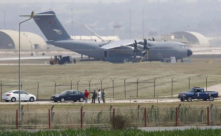 Turkish and U.S. soldiers, with a Turkish Air Force A400M tactical transport aircraft in the background, conduct inspections inside Incirlik airbase in the southern city of Adana, Turkey, July 27, 2015. REUTERS/Murad Sezer