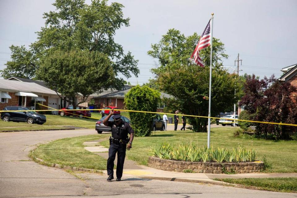 A police officer crossed under a police tape on Thirlstane Court in Lexington Wednesday.