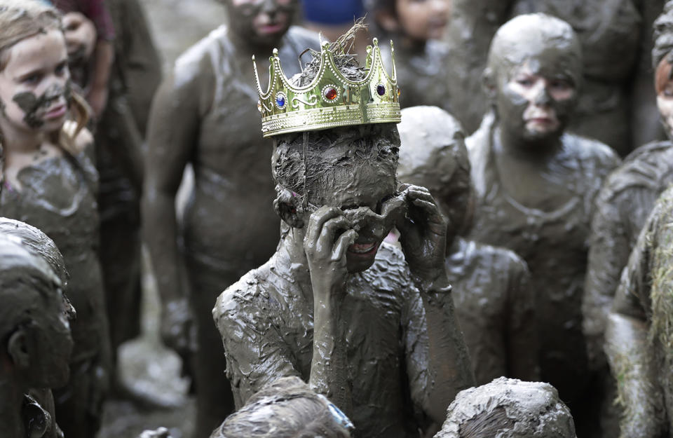 <p>Mackenna Kofahl, 12, removes her goggles after being crowned 2017 Queen of Mud Day at the Nankin Mills Park, July 11, 2017 in Westland, Mich. (Photo: Carlos Osorio/AP) </p>