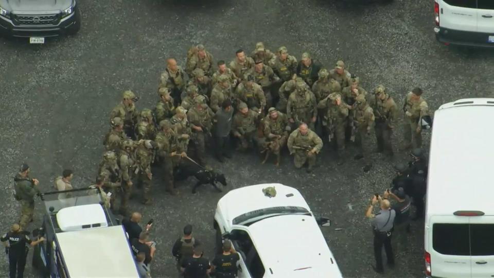 A helicopter from CBS Philadelphia station KYW captured an aerial view of the moments following the convict's apprehension – showing law enforcement posing for a group photo with Cavalcante. / Credit: KYW