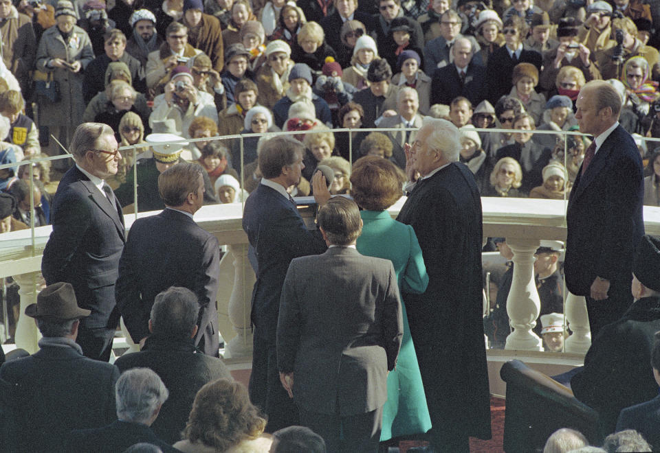 FILE - U.S. President Jimmy Carter, center left, takes the oath of office as the 39th president of the United States, administered by Chief Justice of the United States Warren E. Burger, right, at the east portico of the Capitol in Washington, Jan. 20, 1977. Carter announced his campaign for the presidency in December 1974. At that point he had never met an American president. He later said part of what nudged him into the race was meeting several candidates ahead of the 1972 campaign and concluding that he was talented as they were. (AP Photo, File)