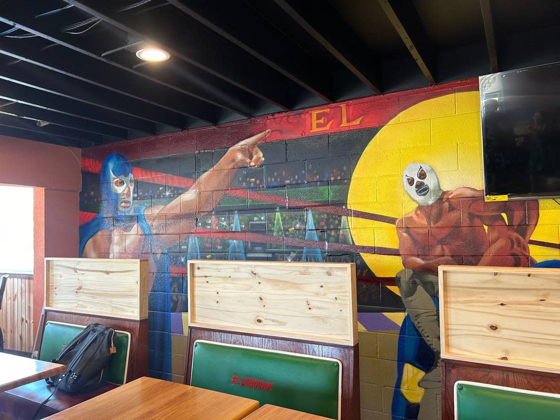 A mural painted by IT-RA Icons wraps around the inside of El Luchador, a new restaurant in Gardner.