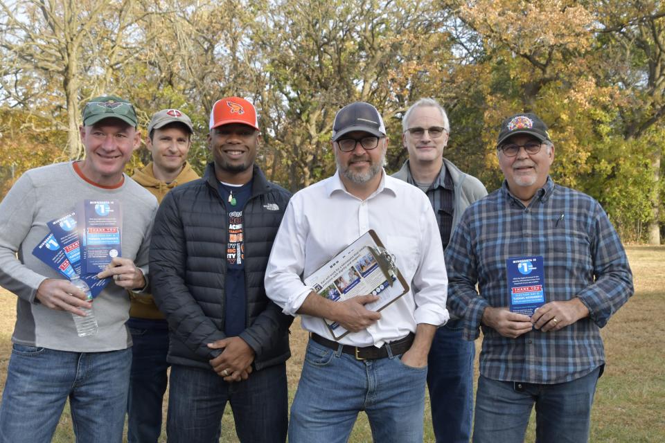 Dads on the Doors co-founder Paul Winkelaar, third from right, and other fathers have been going door to door in Minnesota supporting state Senate candidates who support abortion rights.