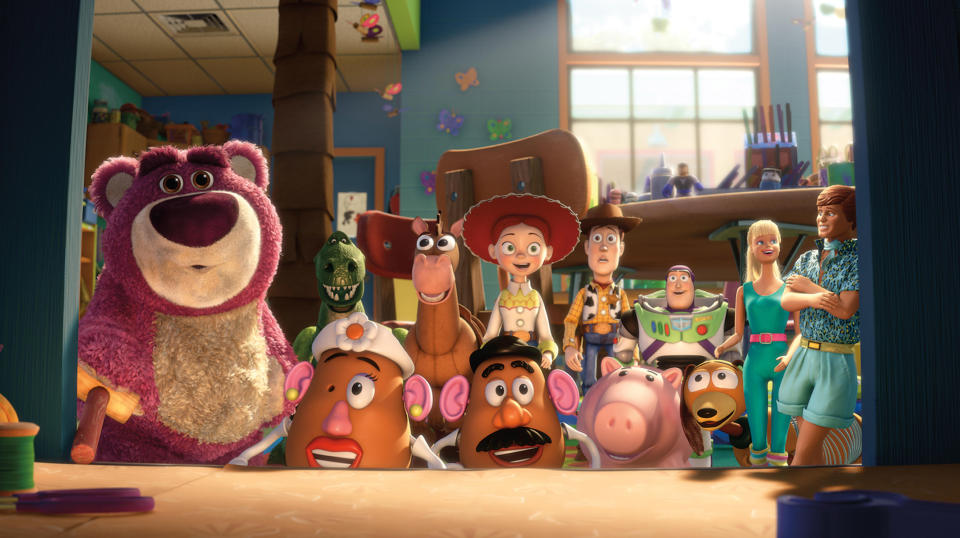 Image depicting characters from Toy Story 3, including Lotso, Rex, Mr. Potato Head, Woody, Jessie, Hamm, and others, all gathered inside a room looking forward
