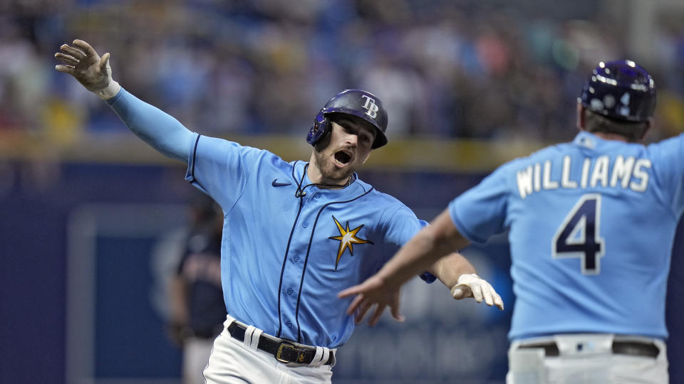 Tampa Bay Rays' Brandon Lowe celebrates with third base coach Brady Williams (4) after his solo home run off Boston Red Sox relief pitcher Chris Martin during the eighth inning of a baseball game Monday, April 10, 2023, in St. Petersburg, Fla. (AP Photo/Chris O'Meara)