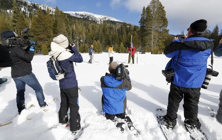 Frank Gehrke, (in red jacket) takes a snowpack measurement during the first snow survey of winter conducted by the California Department of Water Resources in Phillips, California December 30, 2015. REUTERS/Fred Greaves