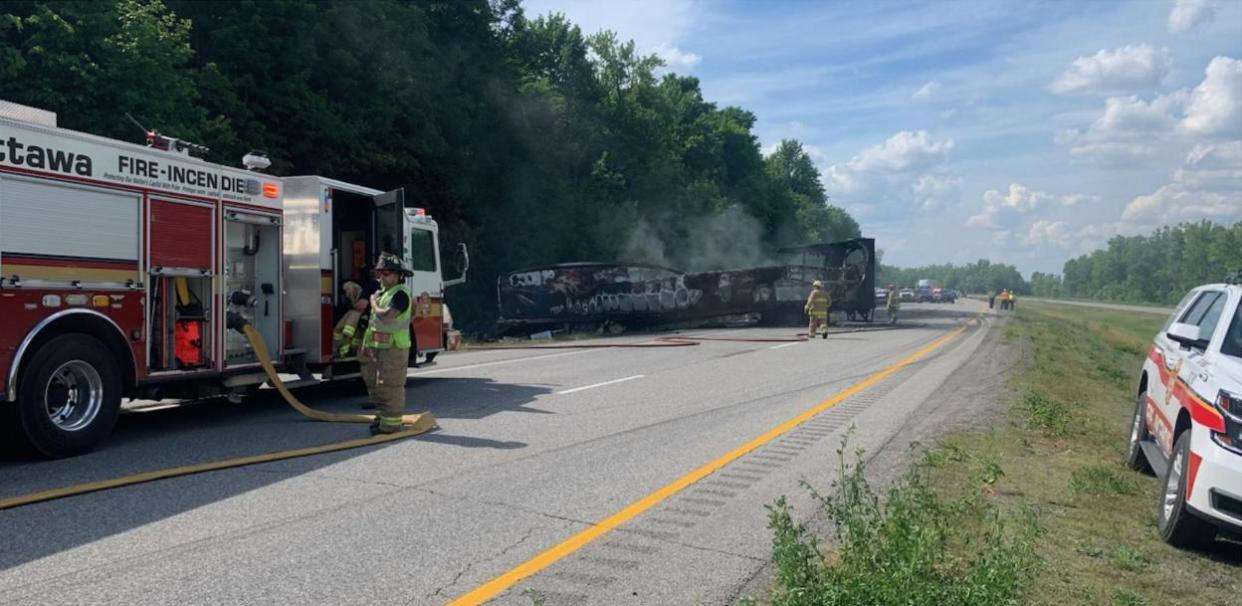 Paramedics say two people were injured Wednesday in a fiery crash between a transport truck and a construction vehicle on Highway 416. (OPP East/X - image credit)