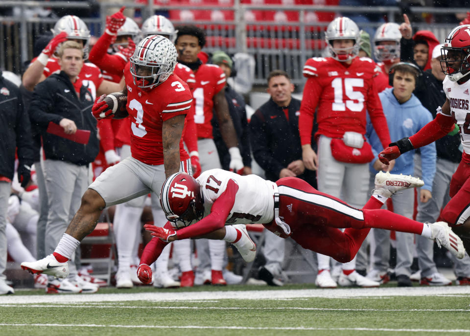 Ohio State running back Miyan Williams, left, tries to get past Indiana defensive back Jonathan Haynes during the first half of an NCAA college football game Saturday, Nov. 12, 2022 in Columbus, Ohio. (AP Photo/Paul Vernon)