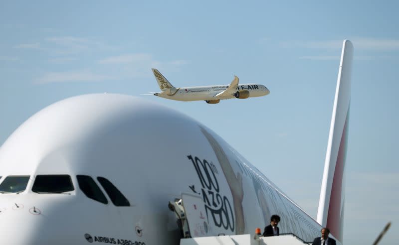 FILE PHOTO: Gulf Air Boeing 787 aircraft makes a fly-by as Emirates Airlines Airbus A380 plane is seen during the Bahrain International Air Show 2018, at Sakhir Air Base