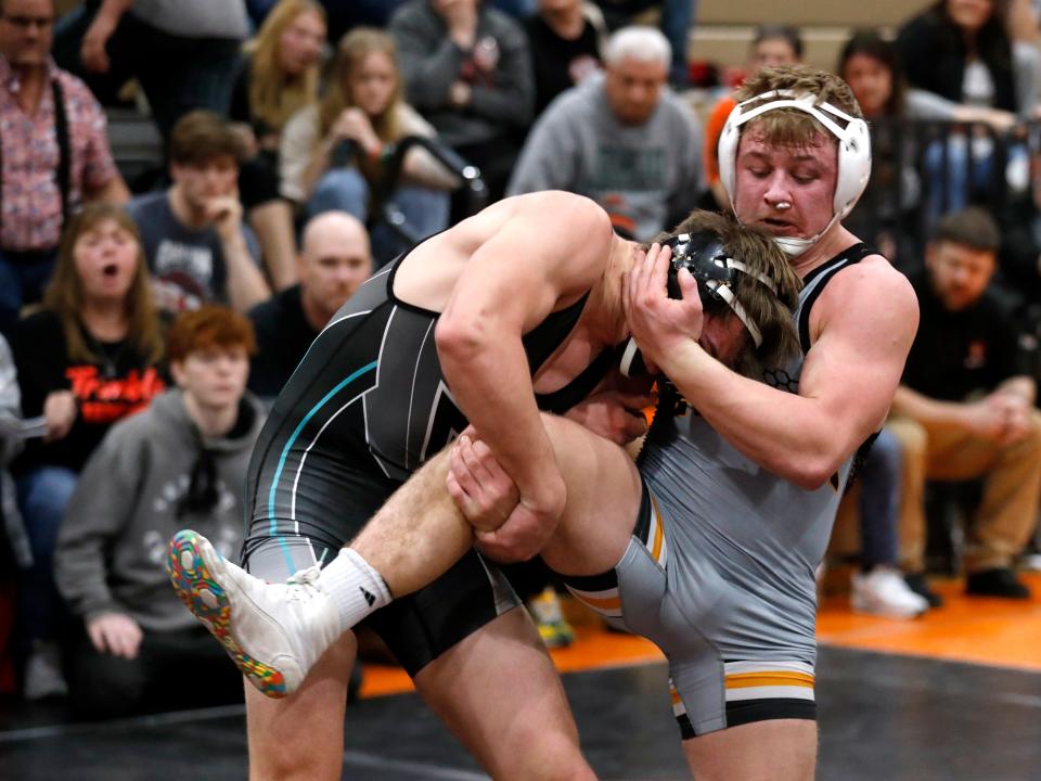 New Lexington senior Hunter Rose wrestles Bidwell River Valley's Justin Stump in the finals at 165 pounds during the annual Jimmy Wood Invitational on Saturday at New Lexington High School. Rose came back from a 5-4 deficit to win, 8-6, in overtime.