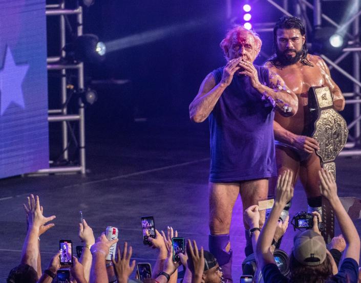Pro wrestling legend Ric Flair, 73, bids farewell to the crowd after his final match of his career at a special event at the Nashville Municipal Auditorium on Sunday, July 31, 2022. 